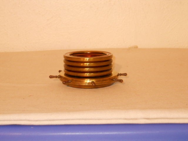   VINTAGE NAUTICAL ASHTRAYS WITH WHEEL HOLDER. BRASS & AMBER GLASS