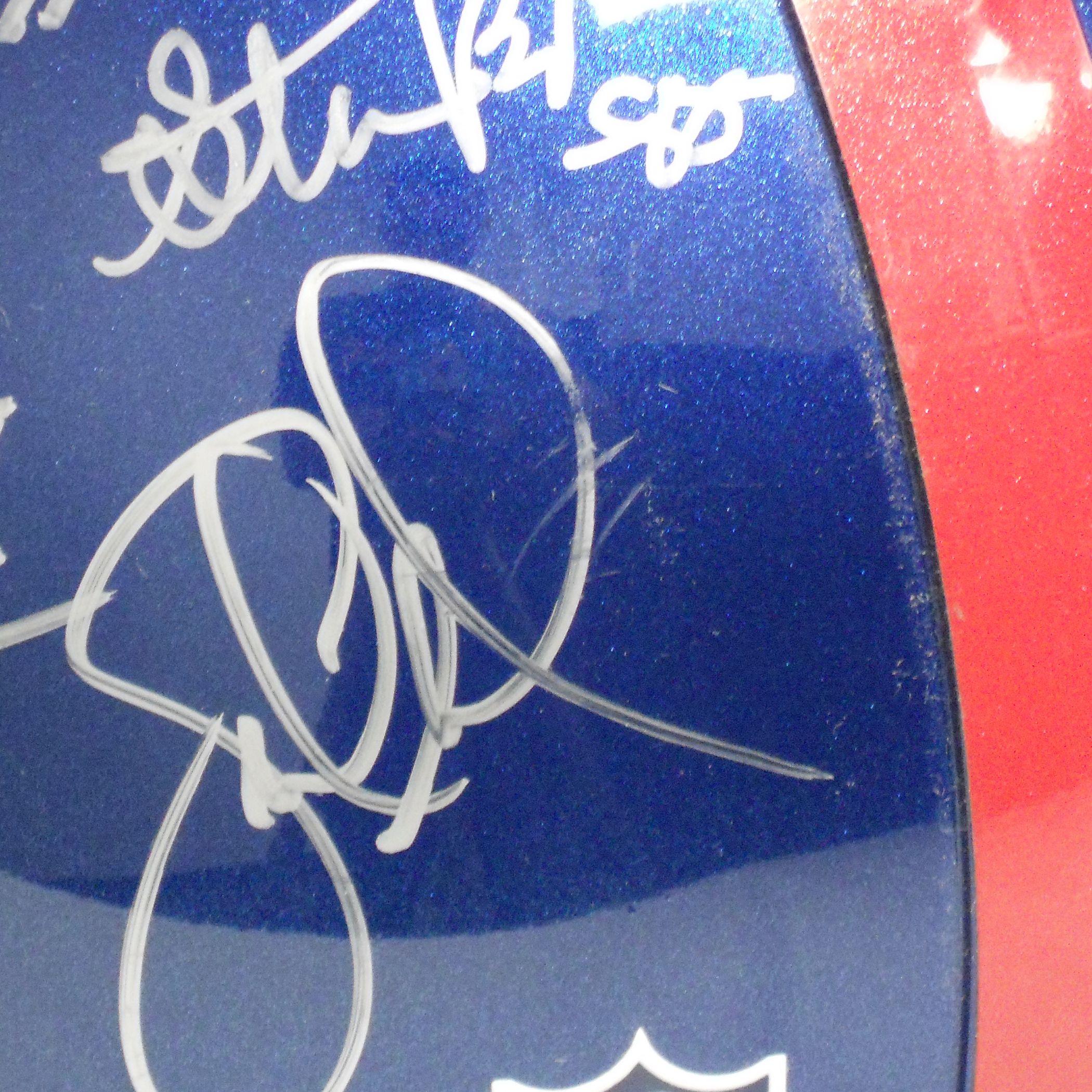 couple of the signatures are slightly smudged. The helmet has minor 