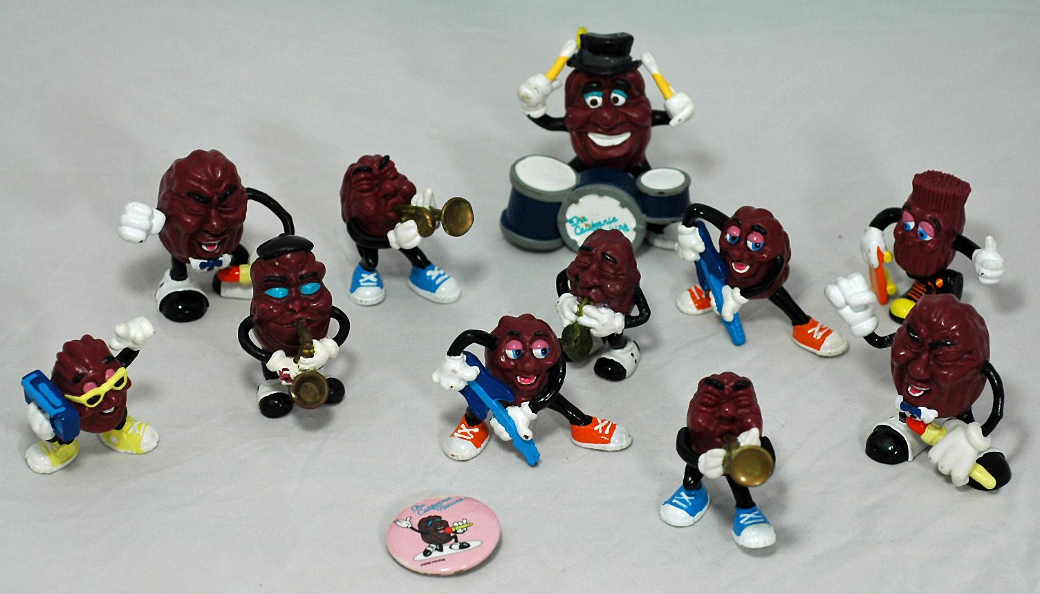 Lot of 13 California Raisin Figurines and A California Raisin Pin Back